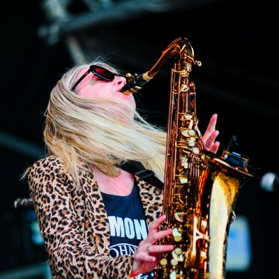 Liz Mitchell playing tenor saxophone at outdoor festival