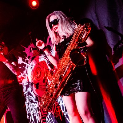 Liz Mitchell with baritone saxophone performing with The Middlenight Men