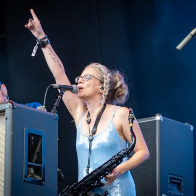Liz Mitchell performing at festival main stage in blue dress